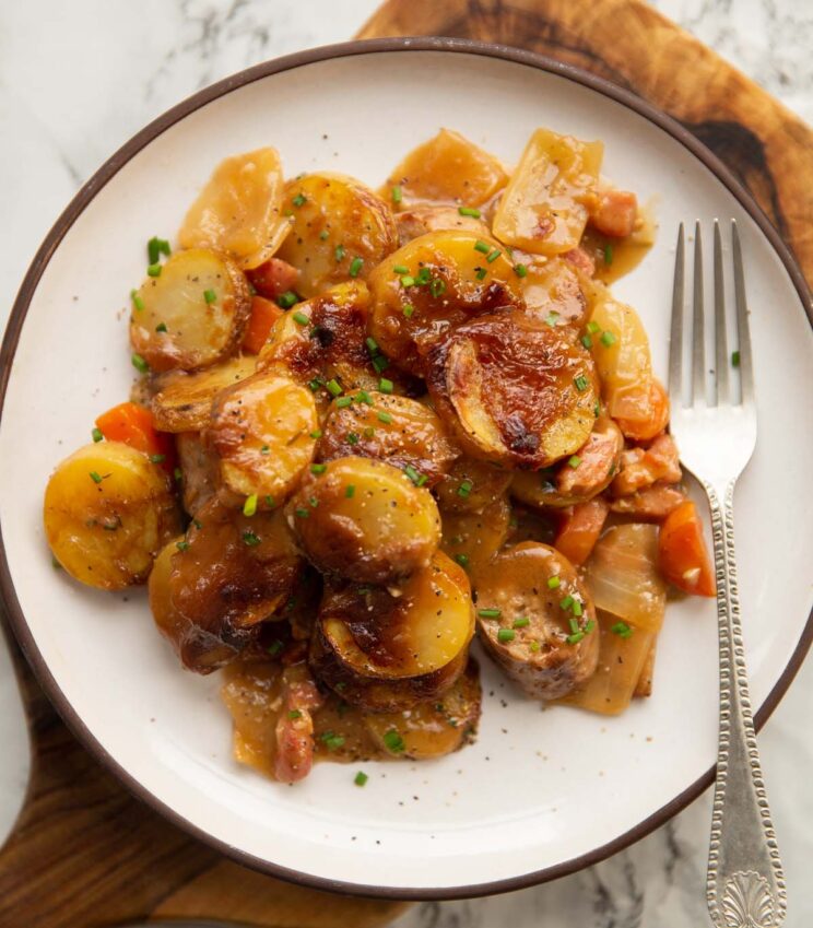 sausage potato bake overhead shot of sausage potato bake served on small white plate with silver fork